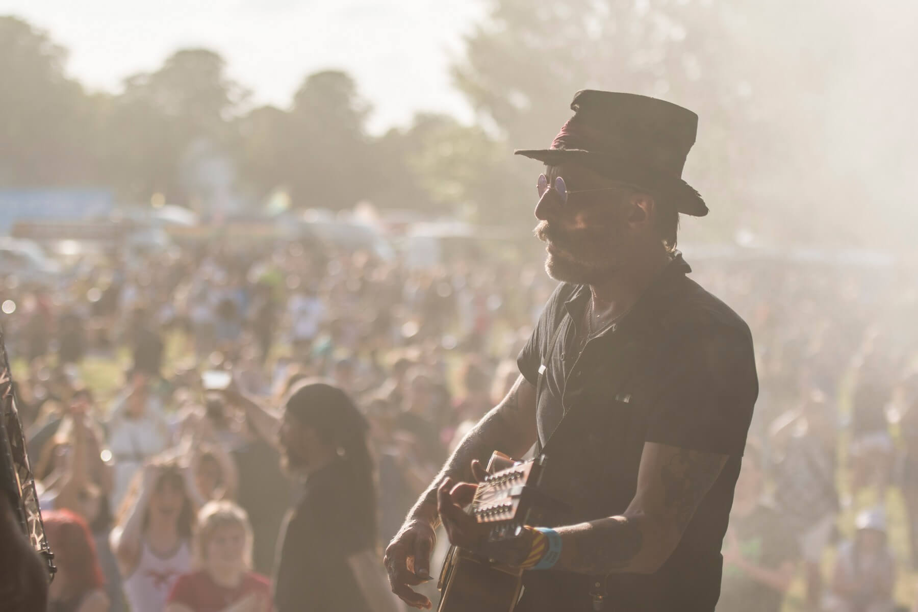 Festival-goers in a shady spot at Strawberry Fair